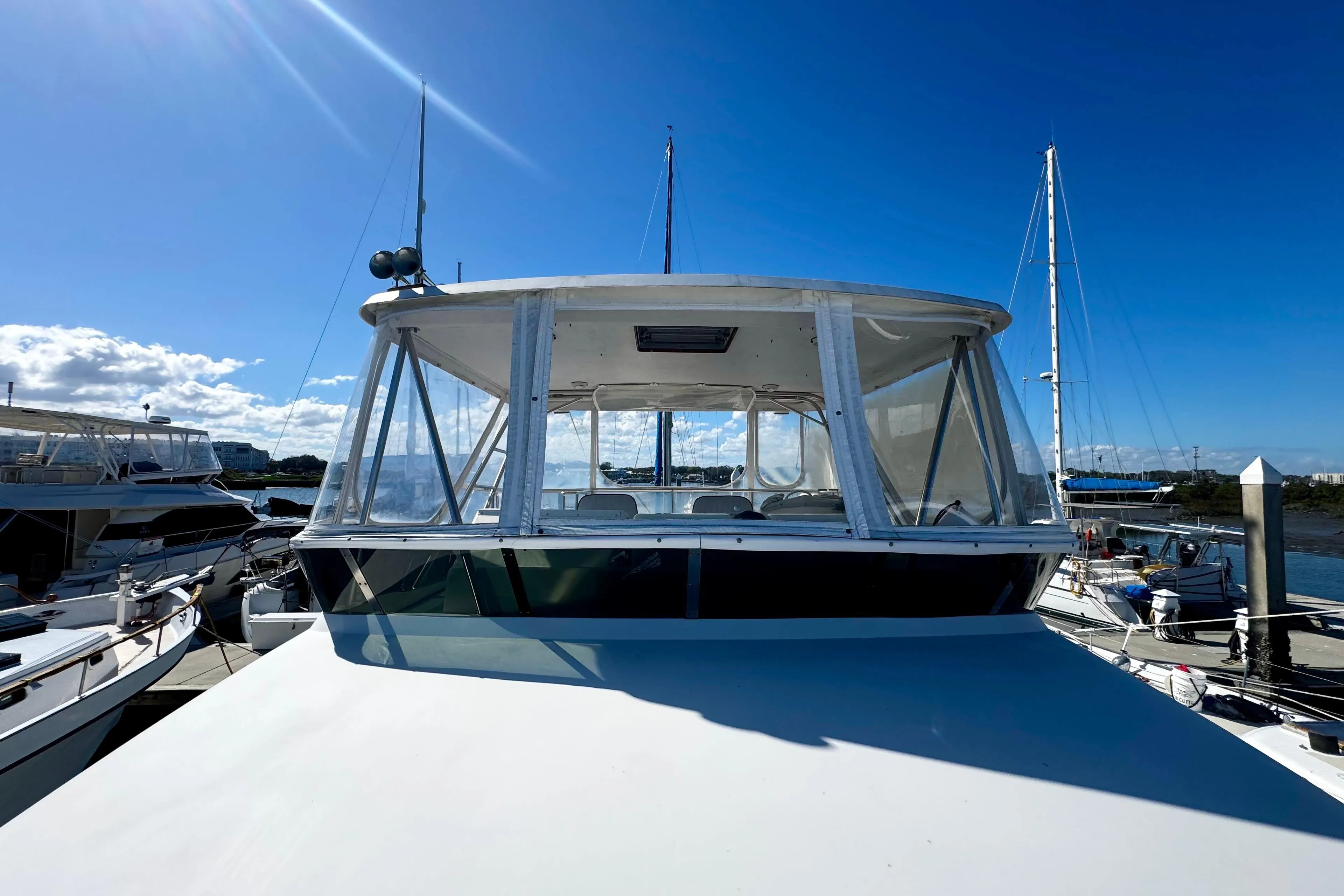 1998 Mikelson 43 Sportfisher yacht docked under clear blue sky.