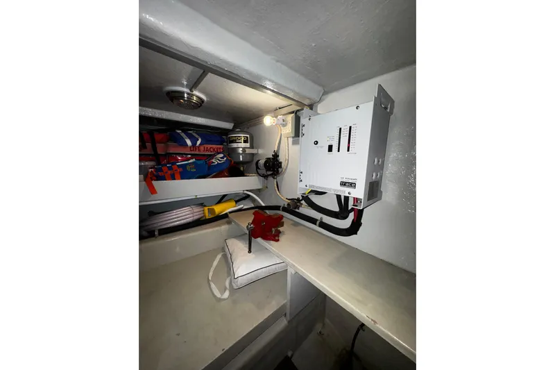 Gullwing Yacht Photos Pics Electrical panel and storage area in 1998 Mikelson 43 Sportfisher boat.