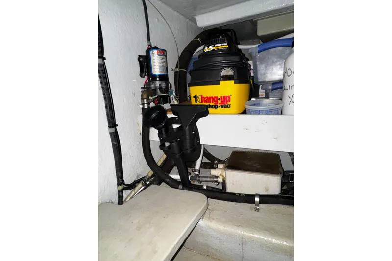 Gullwing Yacht Photos Pics Engine room of 1998 Mikelson 43 Sportfisher with equipment and storage items.