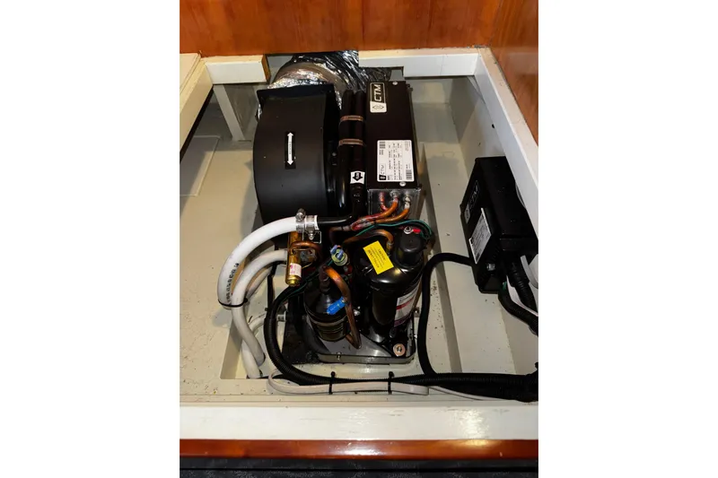 Gullwing Yacht Photos Pics Engine compartment of 1998 Mikelson 43 Sportfisher, showcasing mechanical components and wiring.