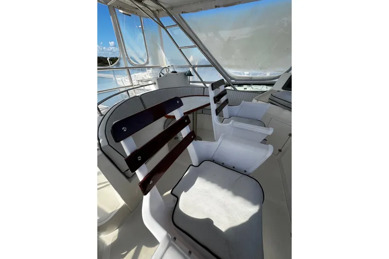 Gullwing Yacht Photos Pics Interior of 1998 Mikelson 43 Sportfisher with white seating and wooden accents.