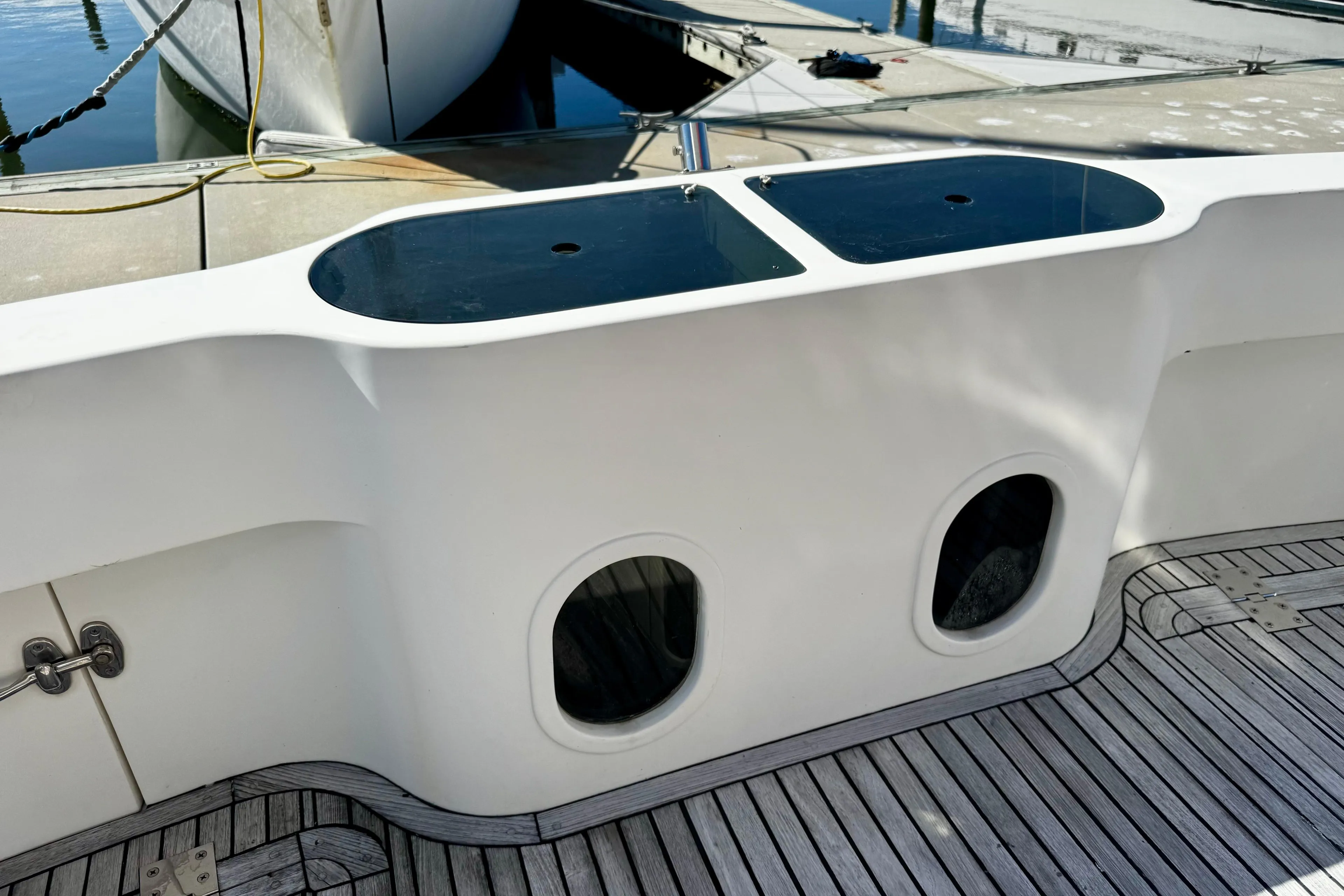 Cockpit view of 1998 Mikelson 43 Sportfisher with teak deck and storage compartments.