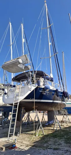  Yacht Photos Pics Beneteau Oceanis Clipper 393 sailboat from 2006 on dry dock with clear blue sky.