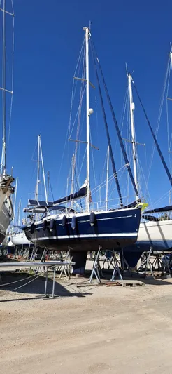  Yacht Photos Pics 2006 Beneteau Oceanis Clipper 393 sailboat on dry dock under clear blue sky.