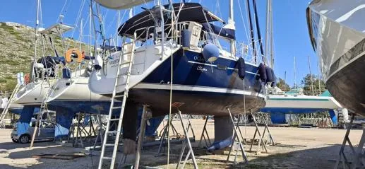  Yacht Photos Pics Beneteau Oceanis Clipper 393 sailboat, 2006 model, on dry dock with ladders and supports.