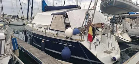  Yacht Photos Pics 2006 Beneteau Oceanis Clipper 393 sailboat docked in marina, featuring blue hull and white canopy.