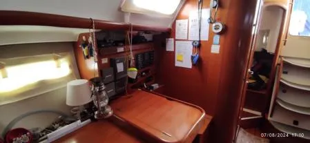  Yacht Photos Pics Interior of 2006 Beneteau Oceanis Clipper 393 yacht with wooden furnishings and navigation area.