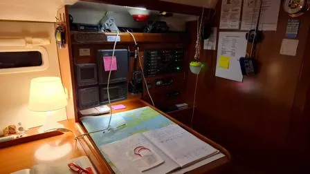  Yacht Photos Pics Navigation station inside a 2006 Beneteau Oceanis Clipper 393 yacht, featuring charts and equipment.