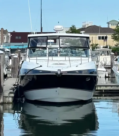  Yacht Photos Pics 2011 Cruisers Yachts 330 Express docked in a marina.