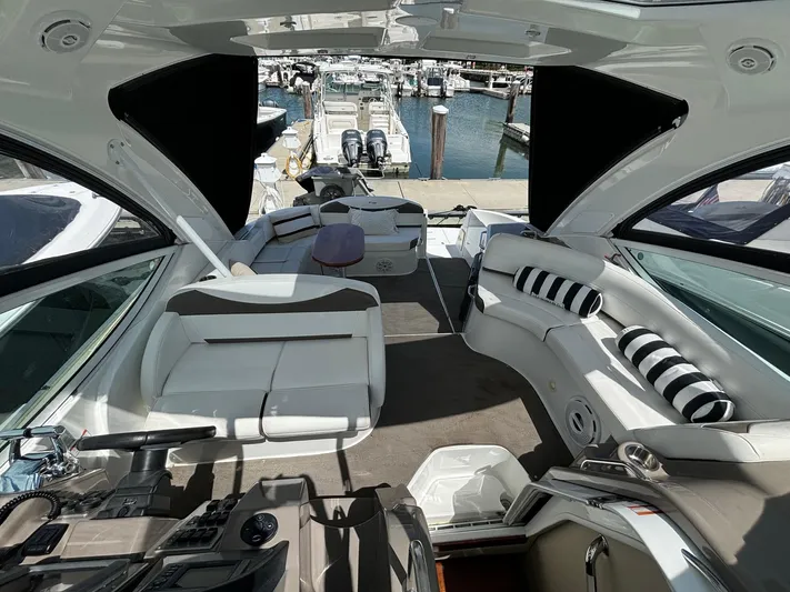  Yacht Photos Pics Luxurious 2011 Cruisers Yachts 330 Express interior with plush seating and marina view.