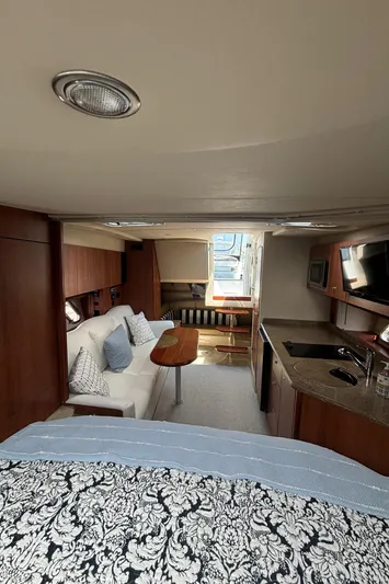  Yacht Photos Pics Interior of 2011 Cruisers Yachts 330 Express, featuring a cozy cabin and kitchenette.