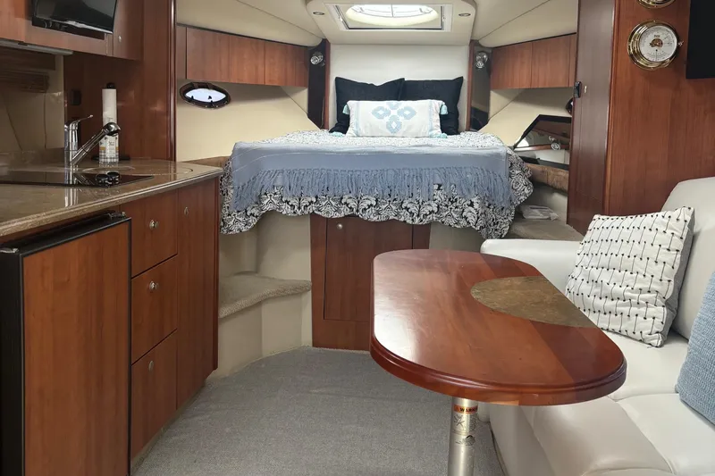  Yacht Photos Pics Luxurious interior of 2011 Cruisers Yachts 330 Express with cozy bed and elegant wood finishes.