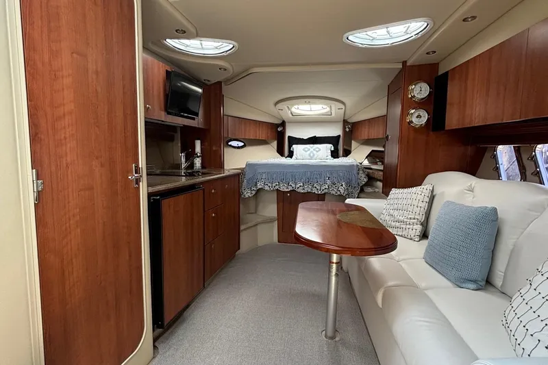  Yacht Photos Pics Luxurious interior of 2011 Cruisers Yachts 330 Express with cozy seating and elegant wood finishes.