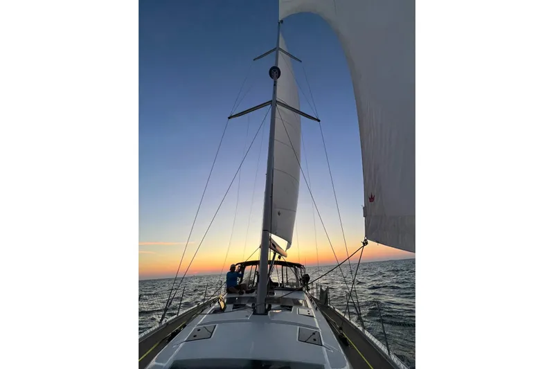  Yacht Photos Pics Sailing Dufour 530 yacht at sunset, 2023 model, on open sea.