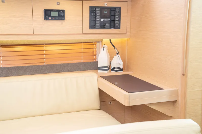  Yacht Photos Pics Interior of 2023 Dufour 530 yacht with modern navigation panel and cozy seating area.