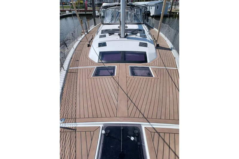  Yacht Photos Pics 2023 Dufour 530 sailboat deck with sleek wood finish and modern design.