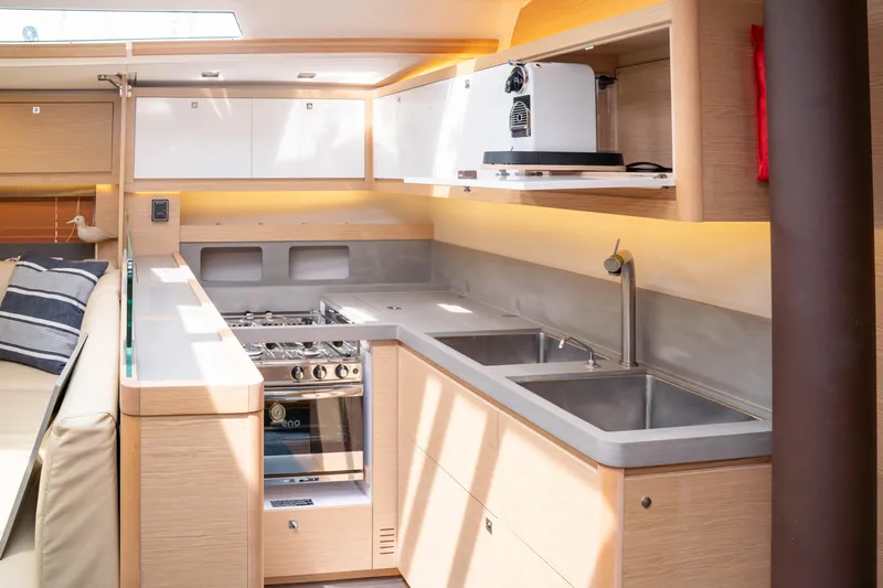  Yacht Photos Pics Modern kitchen interior of 2023 Dufour 530 yacht with sleek design and appliances.