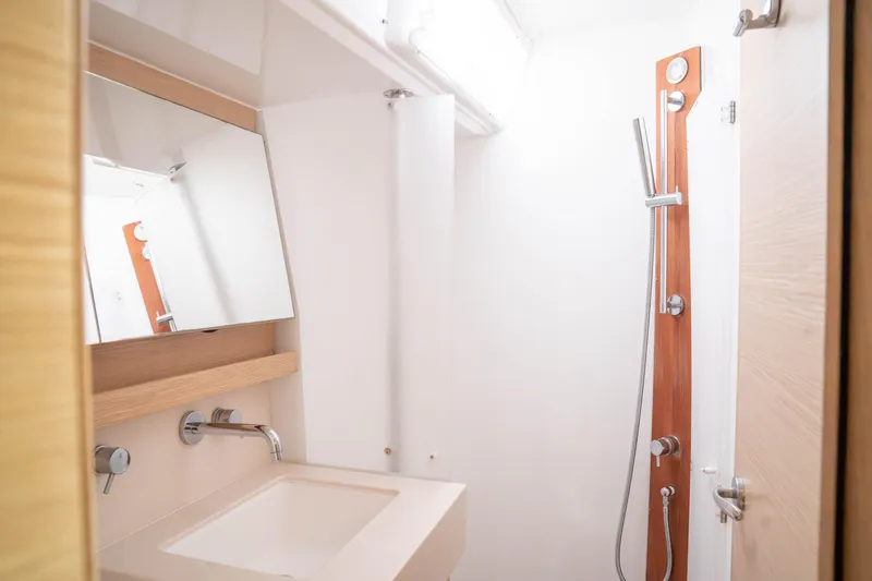  Yacht Photos Pics Modern bathroom in 2023 Dufour 530 yacht with sleek shower and sink.
