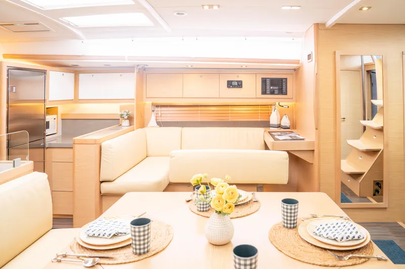  Yacht Photos Pics Luxurious interior of 2023 Dufour 530 yacht with modern kitchen and dining area.