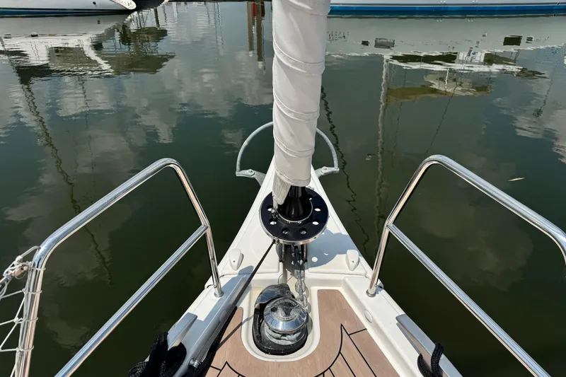  Yacht Photos Pics Bow of 2023 Dufour 530 yacht with polished deck and railing reflections.
