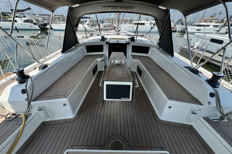  Yacht Photos Pics 2023 Dufour 530 yacht cockpit with teak flooring and spacious seating at marina.