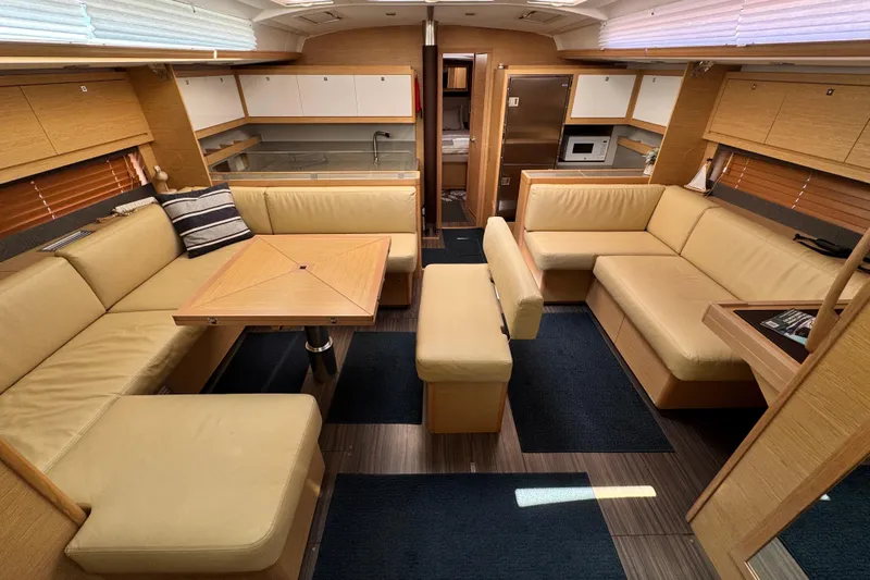  Yacht Photos Pics Luxurious interior of 2023 Dufour 530 yacht with beige seating and modern kitchen.