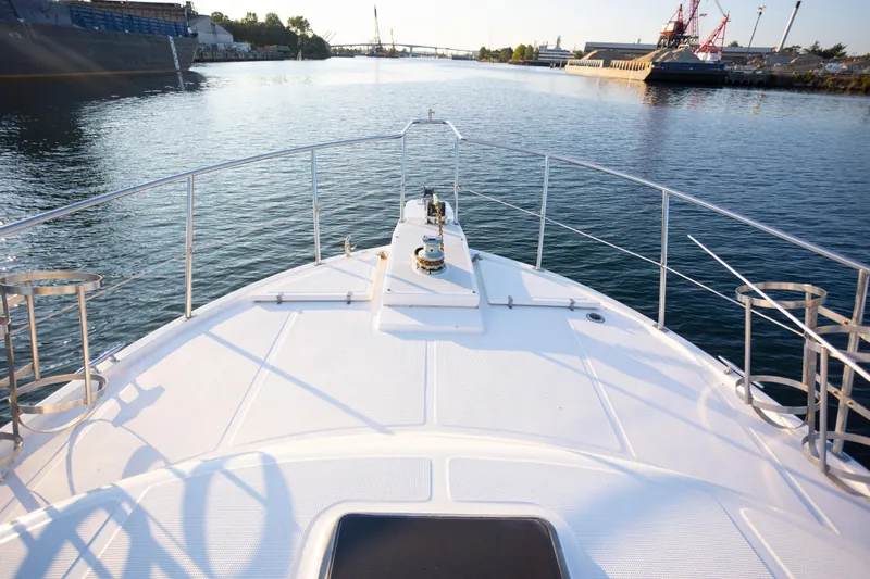 Mbellish Yacht Photos Pics Bow view of 1988 Symbol 51 Motoryacht on calm waterway.
