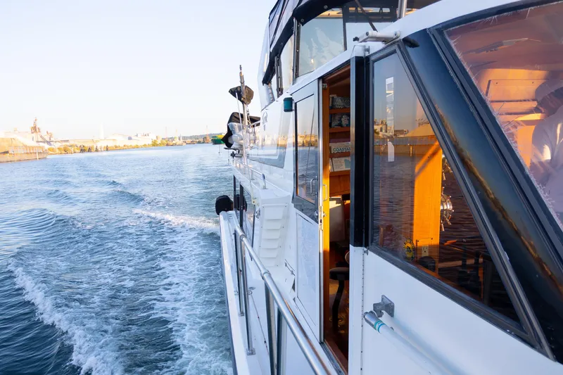 Mbellish Yacht Photos Pics 1988 Symbol 51 Motoryacht cruising on a sunny day, leaving a wake behind.
