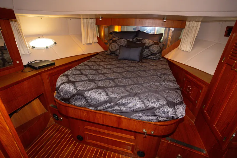 Mbellish Yacht Photos Pics Luxurious cabin interior of 1988 Symbol 51 Motoryacht with elegant bedding and wood finish.