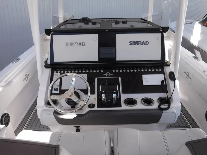  Yacht Photos Pics 2018 Fountain 34CC boat dashboard with dual Simrad displays and steering wheel.