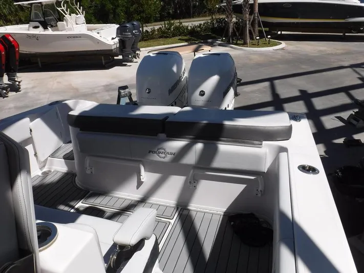  Yacht Photos Pics 2018 Fountain 34CC boat with dual outboard engines, docked in a marina.