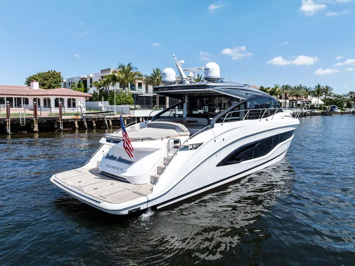 Endless Summer Yacht Photos Pics Luxurious 2020 Princess V55 yacht cruising on a sunny day near waterfront homes.