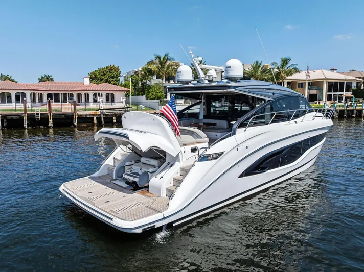 Endless Summer Yacht Photos Pics 2020 Princess V55 yacht docked in a scenic waterfront setting.