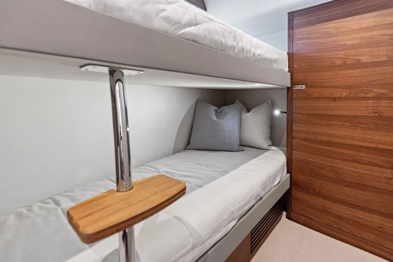 Endless Summer Yacht Photos Pics Interior of 2020 Princess V55 yacht with cozy bunk beds and wooden accents.