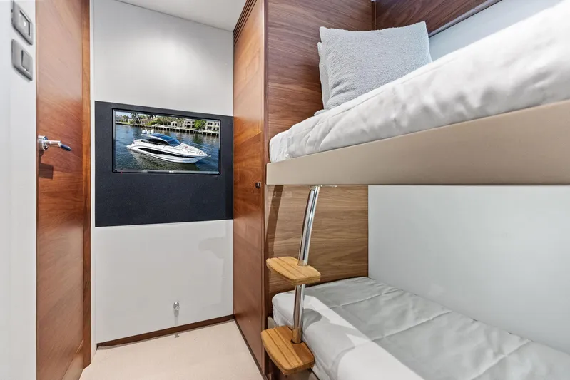 Endless Summer Yacht Photos Pics Interior of 2020 Princess V55 yacht with bunk beds and wall-mounted TV.