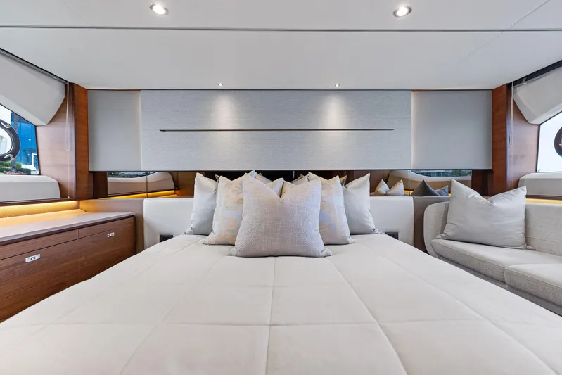 Endless Summer Yacht Photos Pics Luxurious interior of 2020 Princess V55 yacht with elegant bedding and cushions.