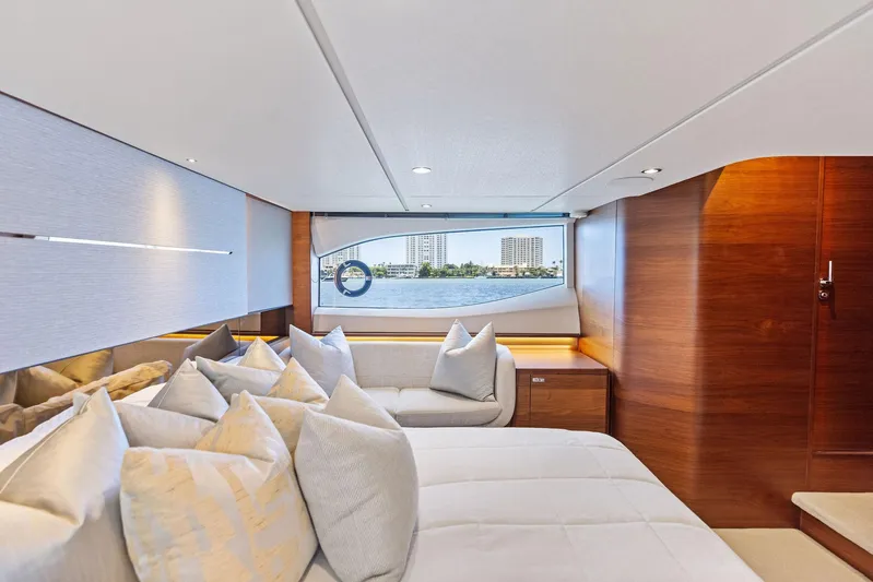Endless Summer Yacht Photos Pics Luxurious interior of 2020 Princess V55 yacht with elegant bedding and scenic window view.