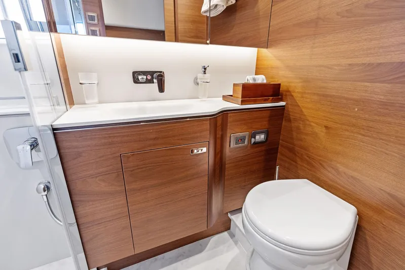 Endless Summer Yacht Photos Pics Luxurious bathroom in 2020 Princess V55 yacht with wooden cabinetry and modern fixtures.