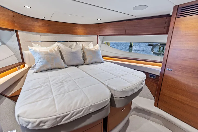 Endless Summer Yacht Photos Pics Luxurious cabin interior of 2020 Princess V55 yacht with elegant bedding and wood accents.