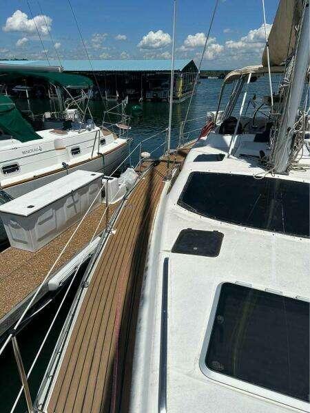 1991 Hunter Passage 42 sailboat docked at marina under clear blue sky.