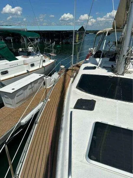1991 Hunter Passage 42 sailboat docked at marina under clear blue sky.