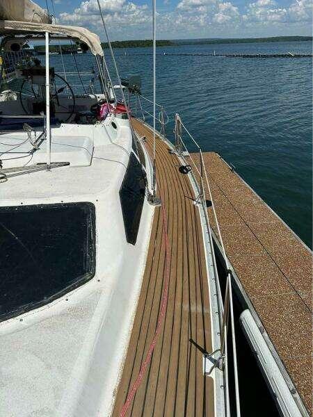 1991 Hunter Passage 42 sailboat docked on calm water under a clear sky.