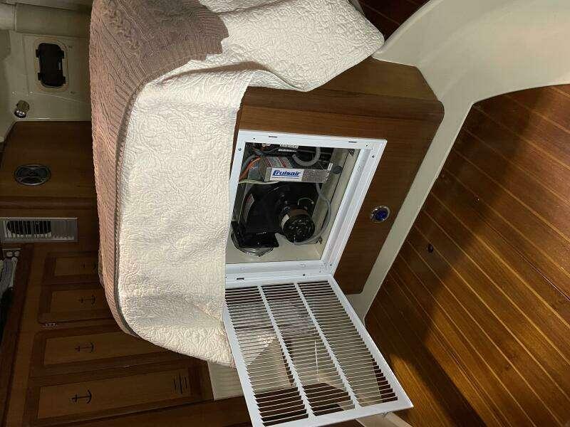 1991 Hunter Passage 42 interior with open cabinet revealing equipment.