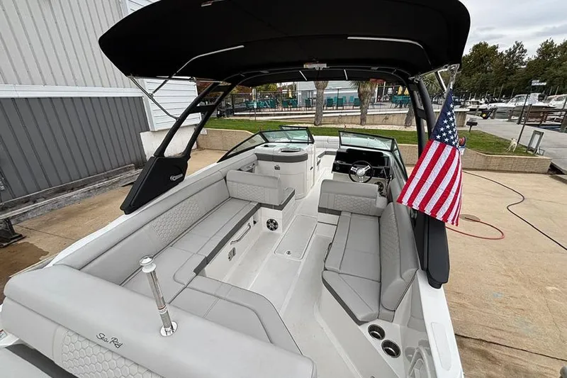  Yacht Photos Pics 2023 Sea Ray SDX 270 Outboard boat interior with seating and American flag.