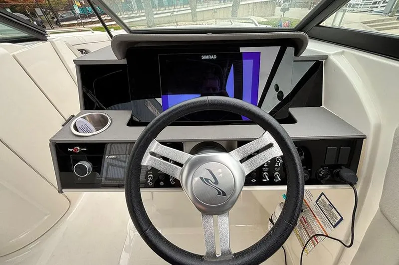  Yacht Photos Pics 2023 Sea Ray SDX 270 Outboard helm with steering wheel and Simrad display.