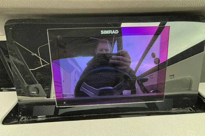  Yacht Photos Pics Simrad display on 2023 Sea Ray SDX 270 Outboard, reflecting a person taking a photo.