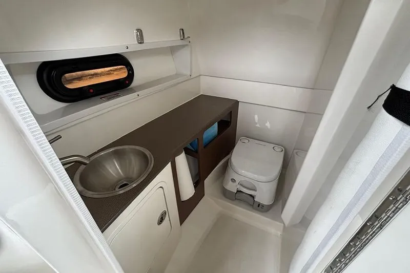  Yacht Photos Pics 2023 Sea Ray SDX 270 Outboard boat bathroom with sink and toilet.