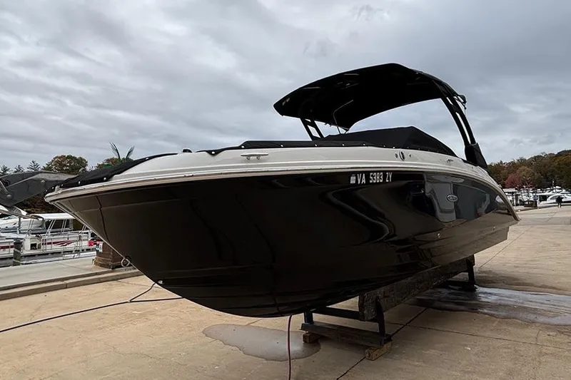  Yacht Photos Pics 2023 Sea Ray SDX 270 Outboard boat on a dock under cloudy skies.