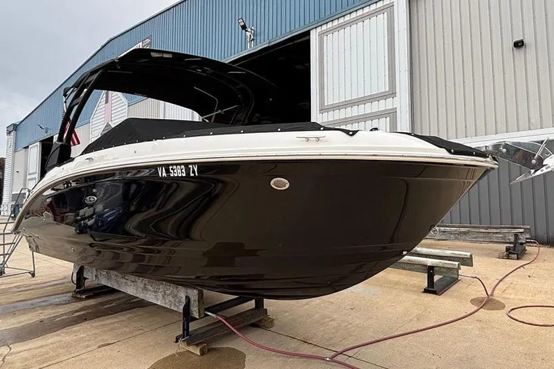  Yacht Photos Pics 2023 Sea Ray SDX 270 Outboard boat on a trailer outside a warehouse.