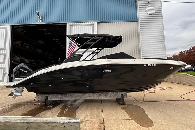  Yacht Photos Pics 2023 Sea Ray SDX 270 Outboard boat on a dock, black hull, American flag displayed.